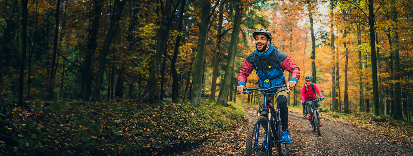 couple biking through woods